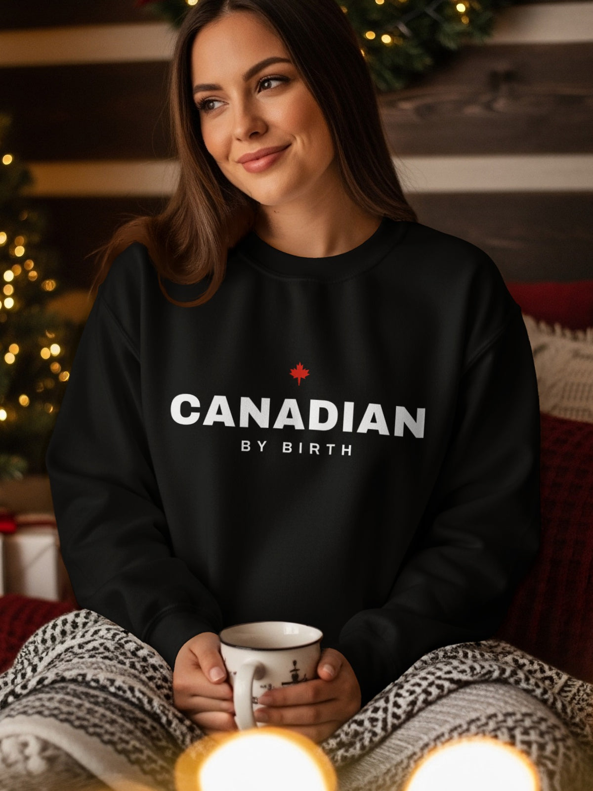 Black sweatshirt with white text "CANADIAN BY BIRTH" and a red maple leaf.