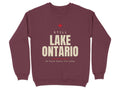 Maroon sweatshirt with "STILL LAKE ONTARIO ON MAPS SINCE THE 1600s" text.