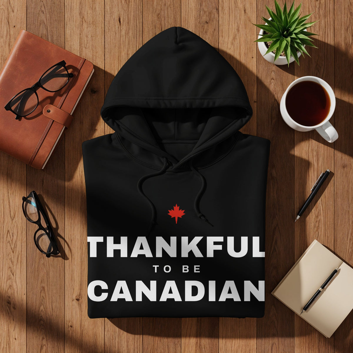 Black hoodie with "Thankful to be Canadian" text and a red maple leaf.