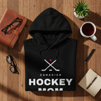 Black hoodie with "CANADIAN HOCKEY MOM" text and hockey sticks graphic.