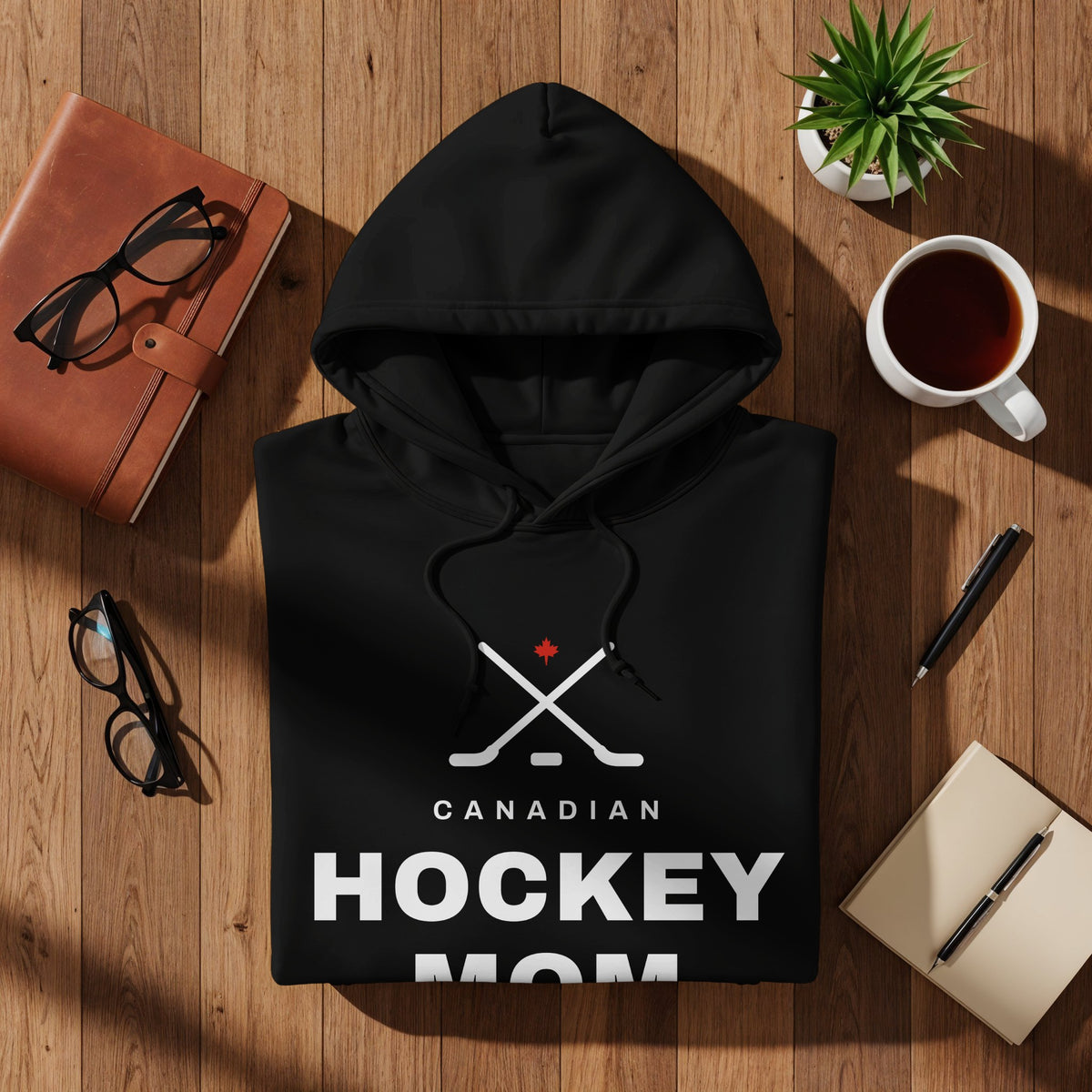 Black hoodie with "CANADIAN HOCKEY MOM" text and hockey sticks graphic.
