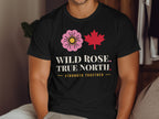 Black t-shirt with pink wild rose, red maple leaf, and text.