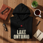 Black hoodie with "Still Lake Ontario" text and a red maple leaf emblem.