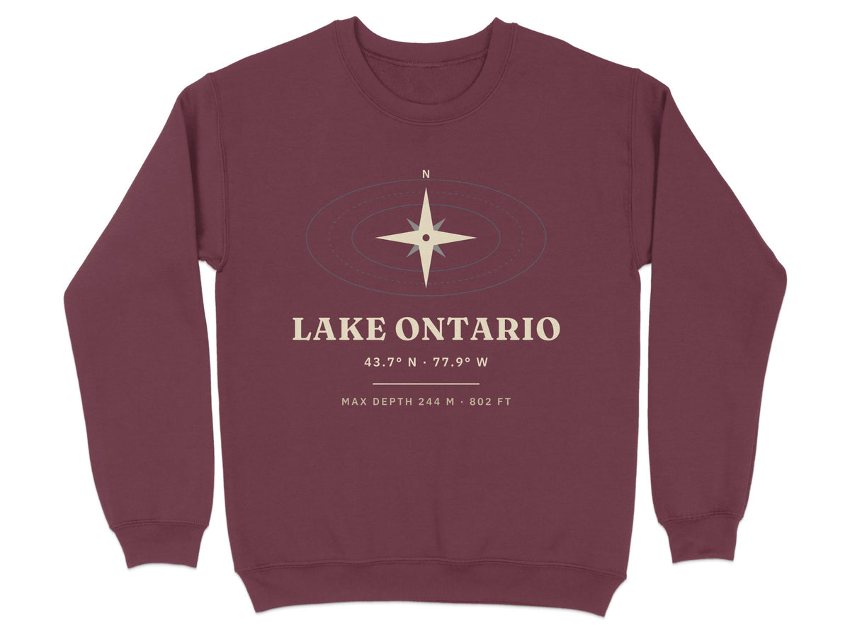 Maroon sweatshirt with Lake Ontario coordinates, depth, and compass graphic.