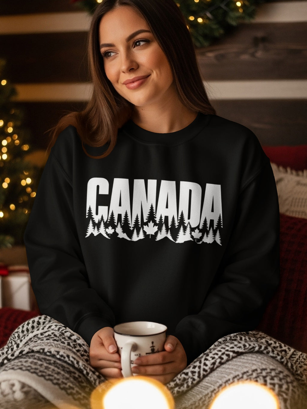 Black sweatshirt with white "CANADA" text, pine trees, and maple leaves.