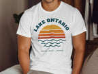 White t-shirt with "Lake Ontario" text and a sunset graphic.
