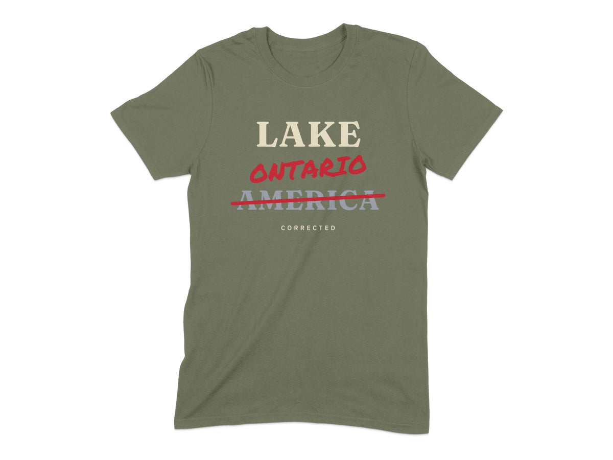 Olive green t-shirt with text "LAKE ONTARIO" and "AMERICA" struck through, "CORRECTED".
