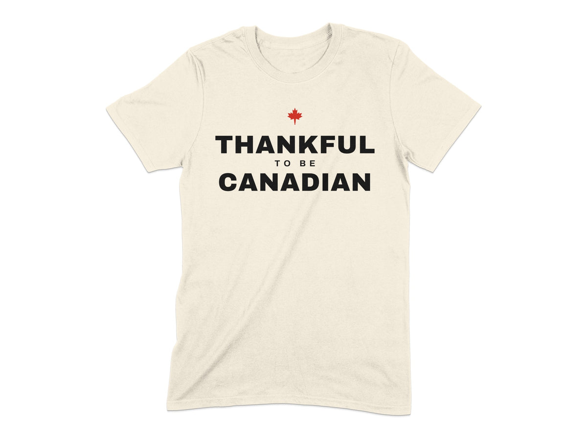 Cream t-shirt with black text "THANKFUL TO BE CANADIAN" and red maple leaf.