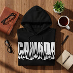 Black hoodie with "CANADA" text and a forest and maple leaf design.
