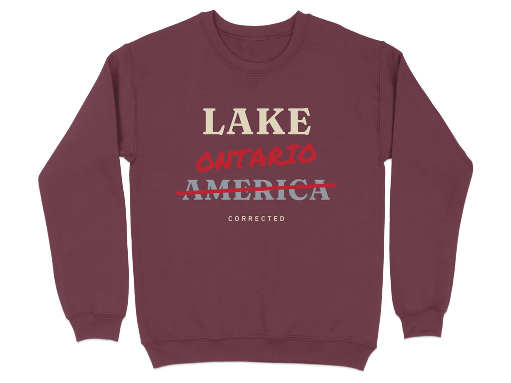 Maroon sweatshirt with text "LAKE ONTARIO" crossed out, and "AMERICA CORRECTED" below.