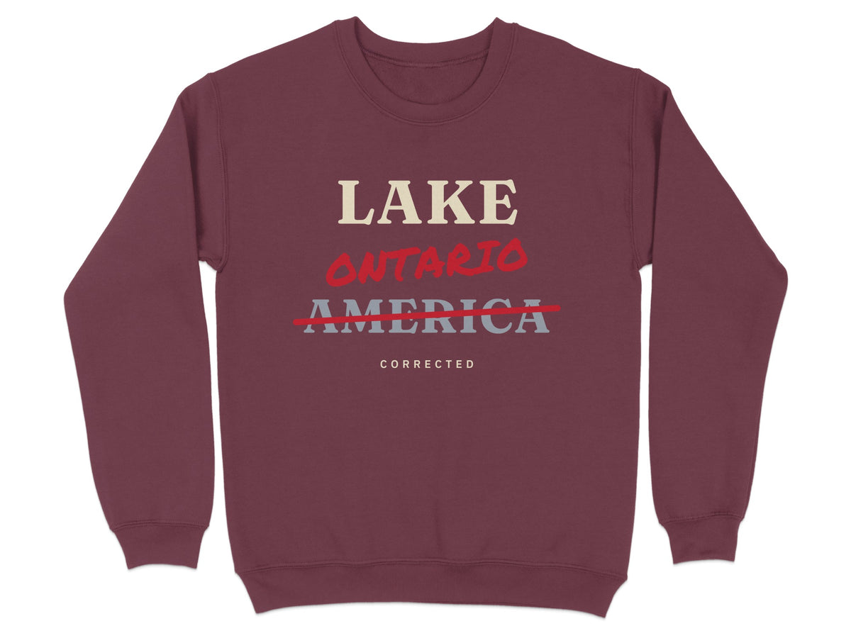 Maroon sweatshirt with text "LAKE ONTARIO" crossed out, and "AMERICA CORRECTED" below.