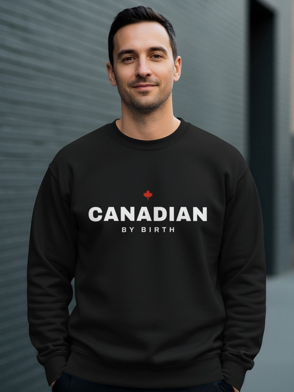 Black sweatshirt with "CANADIAN BY BIRTH" and a red maple leaf.