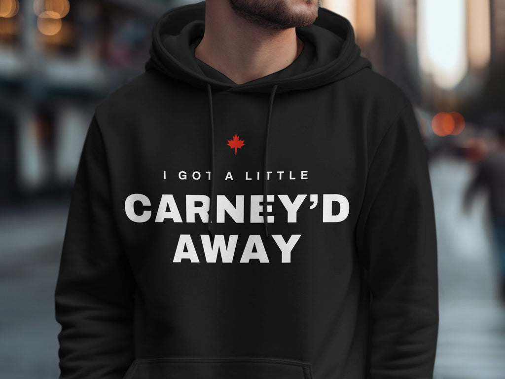 Black hoodie with white text "I GOT A LITTLE CARNEY'D AWAY" and a red maple leaf.