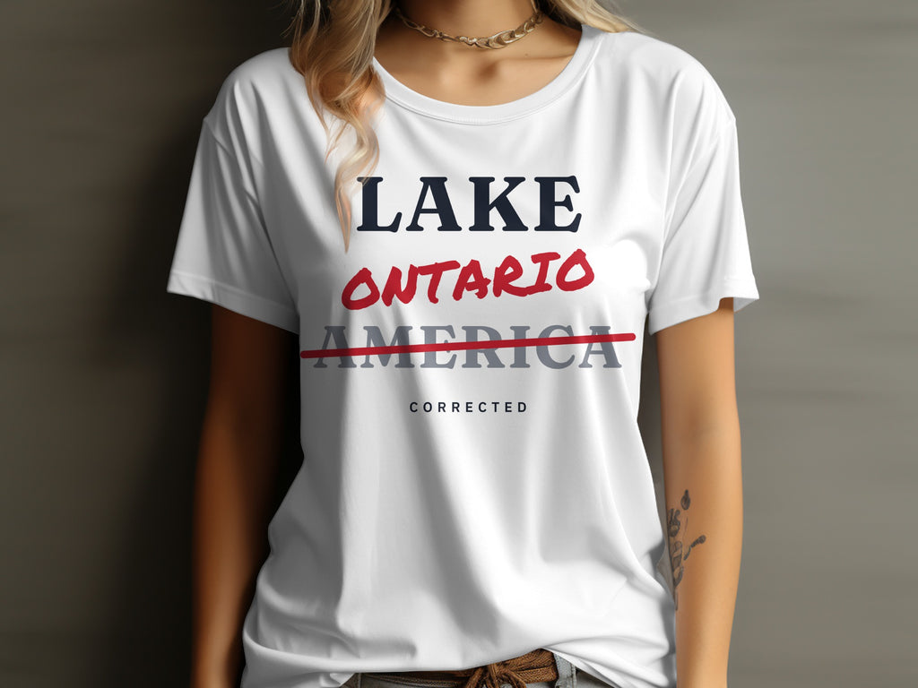 White t-shirt with text "LAKE ONTARIO" and "AMERICA" struck through, "CORRECTED" below.