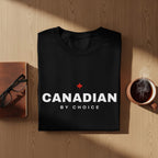 Black t-shirt with white text "CANADIAN BY CHOICE" and a red maple leaf.