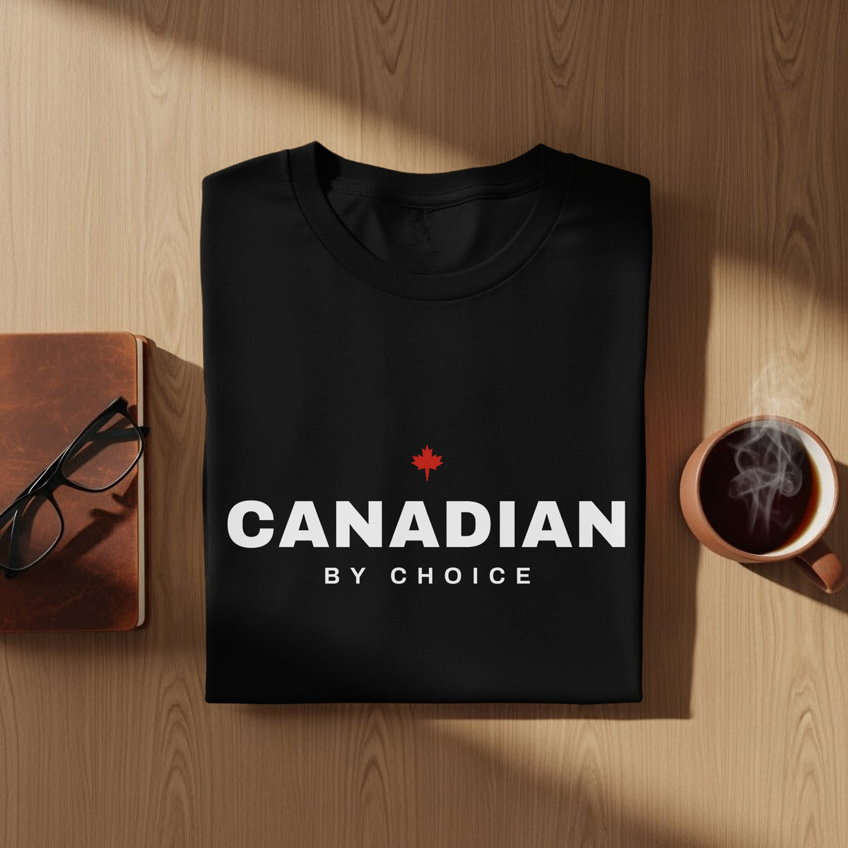 Black t-shirt with white text "CANADIAN BY CHOICE" and a red maple leaf.
