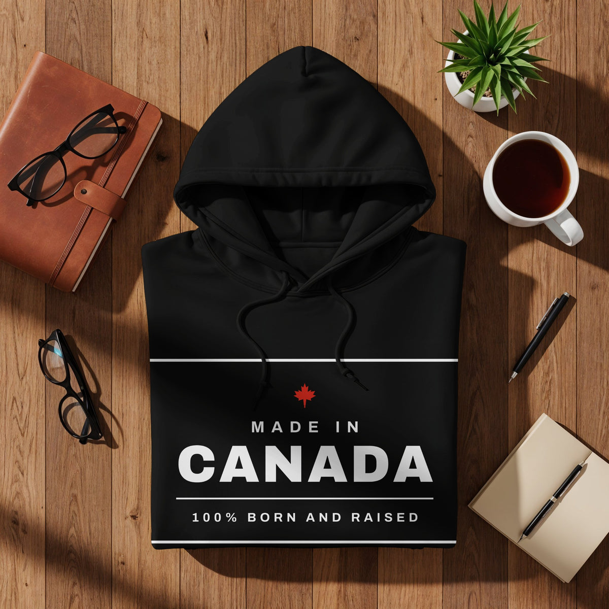 Black hoodie with "Made in Canada" and "100% Born and Raised" text.