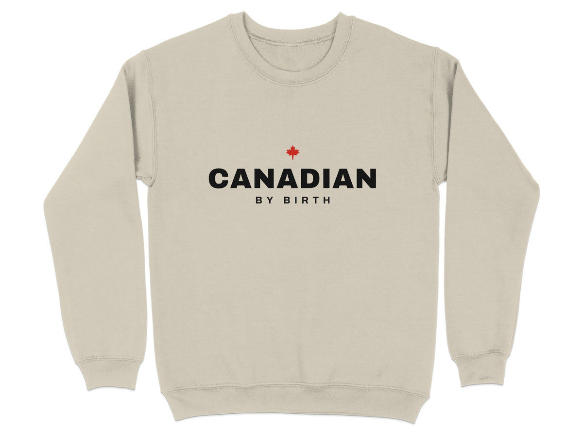 Light tan sweatshirt with black "CANADIAN BY BIRTH" text and a red maple leaf.