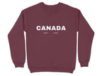 Maroon sweatshirt with "CANADA EST. 1867" and a maple leaf in white text.