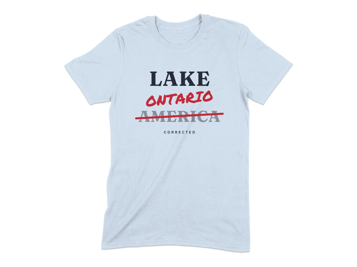 Light blue t-shirt with "LAKE ONTARIO" in red and "AMERICA" struck through in gray, with "CORRECTED" below.