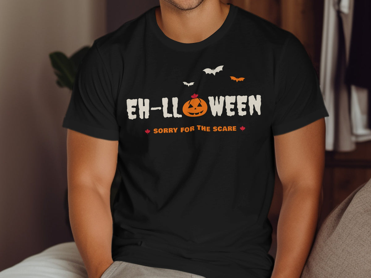 Black t-shirt with "EH-LLOWEEN SORRY FOR THE SCARE" text and pumpkin.