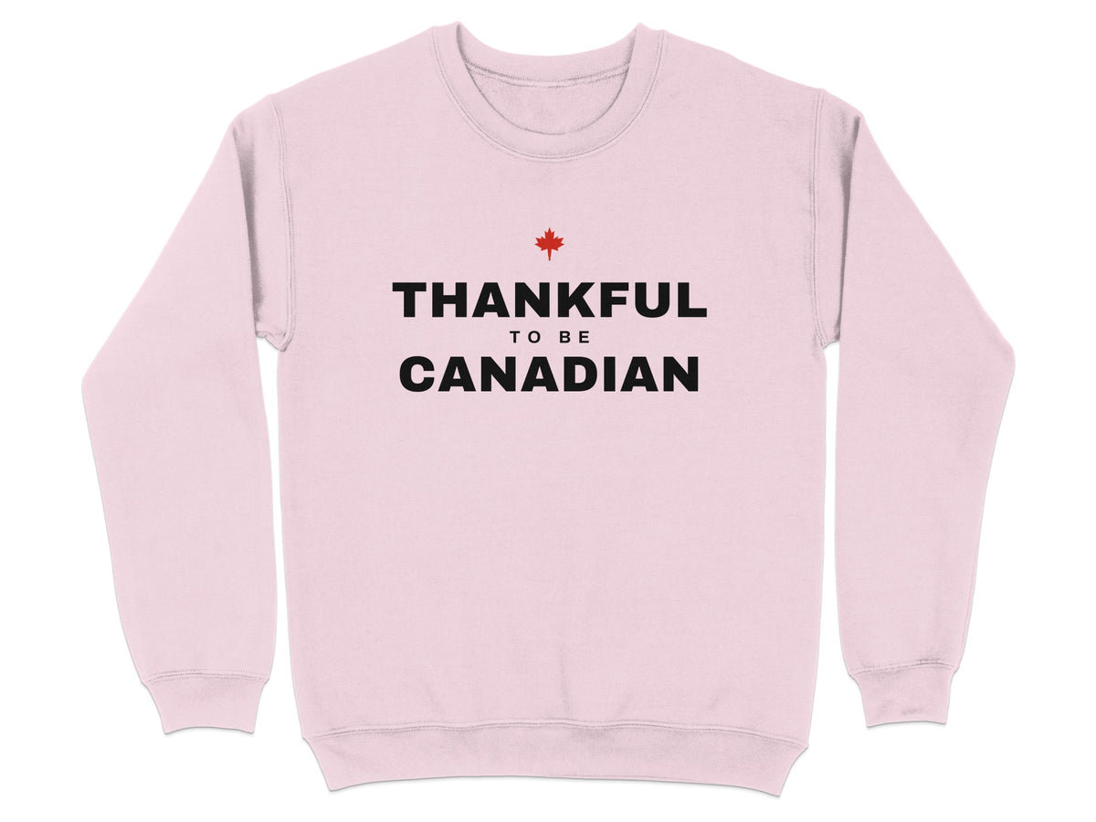 Light pink sweatshirt with black text "Thankful To Be Canadian" and a red maple leaf.