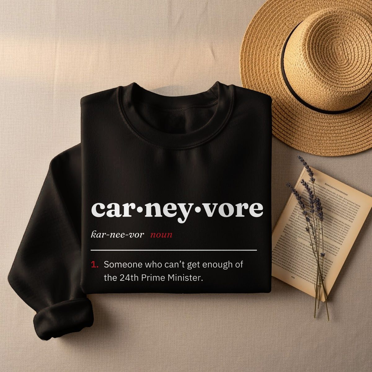 Black sweatshirt with "car•ney•vore" definition: someone who can't get enough of the 24th Prime Minister.