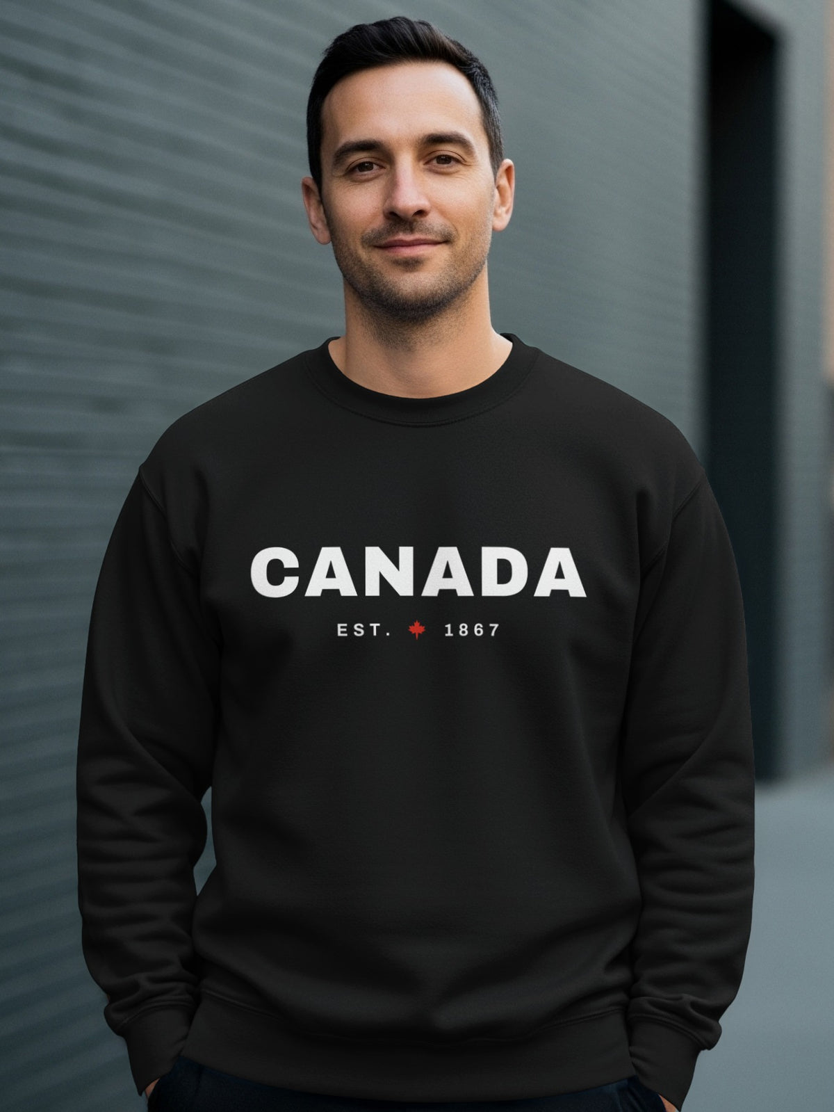 Man wearing black sweatshirt with "CANADA EST. 1867" and a maple leaf.
