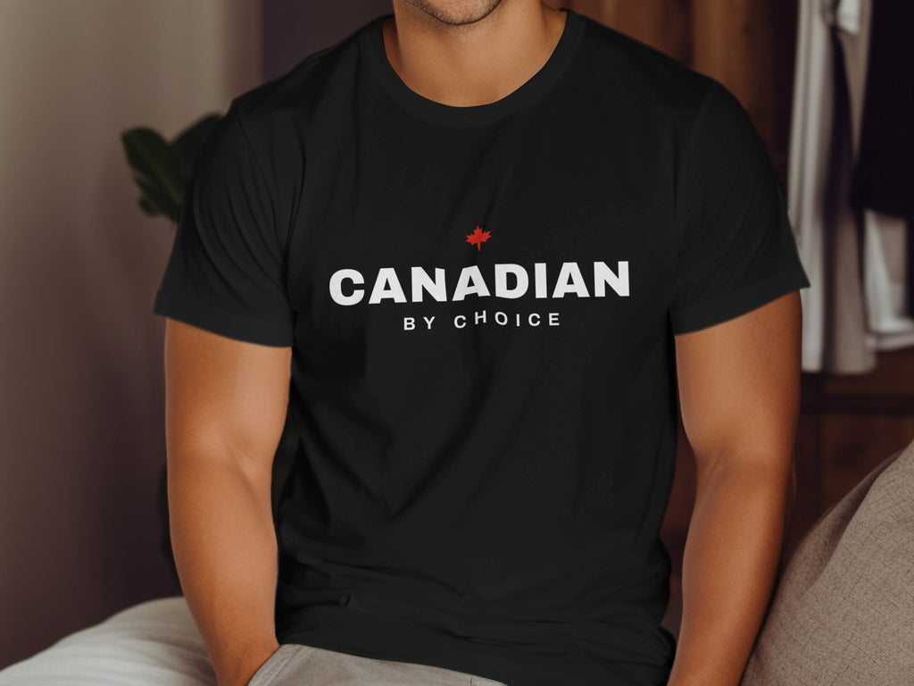 Black t-shirt with white text "CANADIAN BY CHOICE" and a red maple leaf.