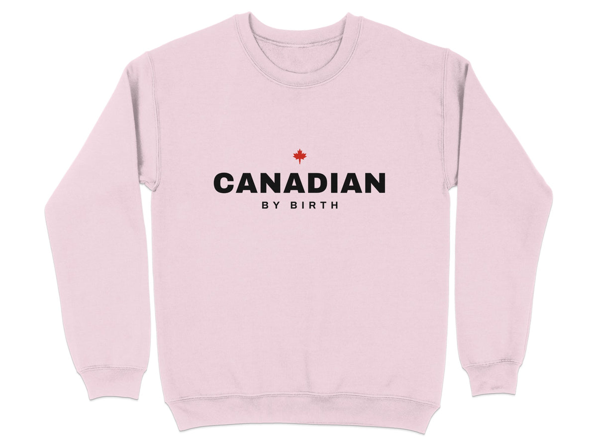 Light pink sweatshirt with black text "CANADIAN BY BIRTH" and a red maple leaf.