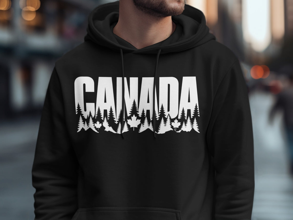 Black hoodie with white text "CANADA" and a forest and maple leaf design.