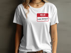 White t-shirt with red name tag reading "HELLO my name is LAKE ONTARIO (STILL)".
