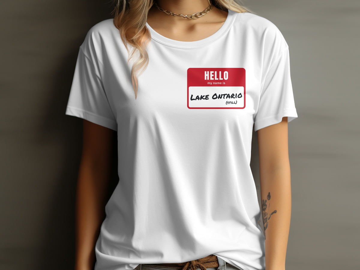 White t-shirt with red name tag reading "HELLO my name is LAKE ONTARIO (STILL)".