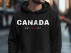 Black hoodie with "CANADA EST. 1867" and a maple leaf.