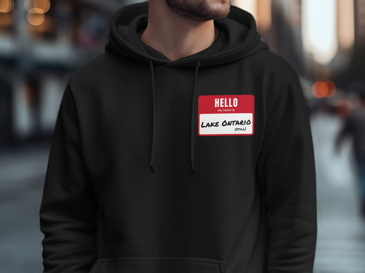 Black hoodie with a red name tag reading "HELLO my name is LAKE ONTARIO (STILL)".