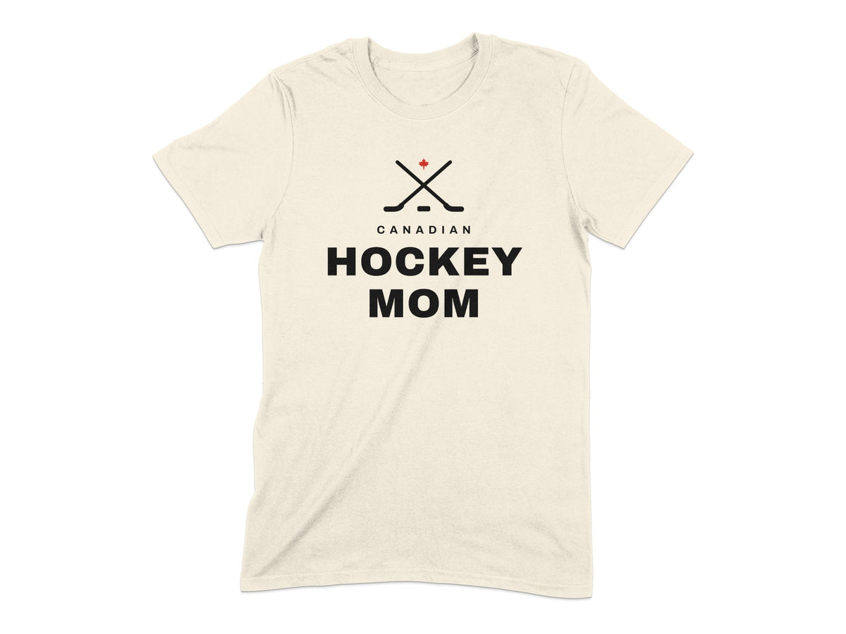Cream t-shirt with crossed hockey sticks, Canadian flag, and "CANADIAN HOCKEY MOM" text.