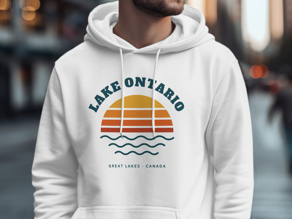 White hoodie with graphic of a retro sunset over waves and text "LAKE ONTARIO GREAT LAKES CANADA".