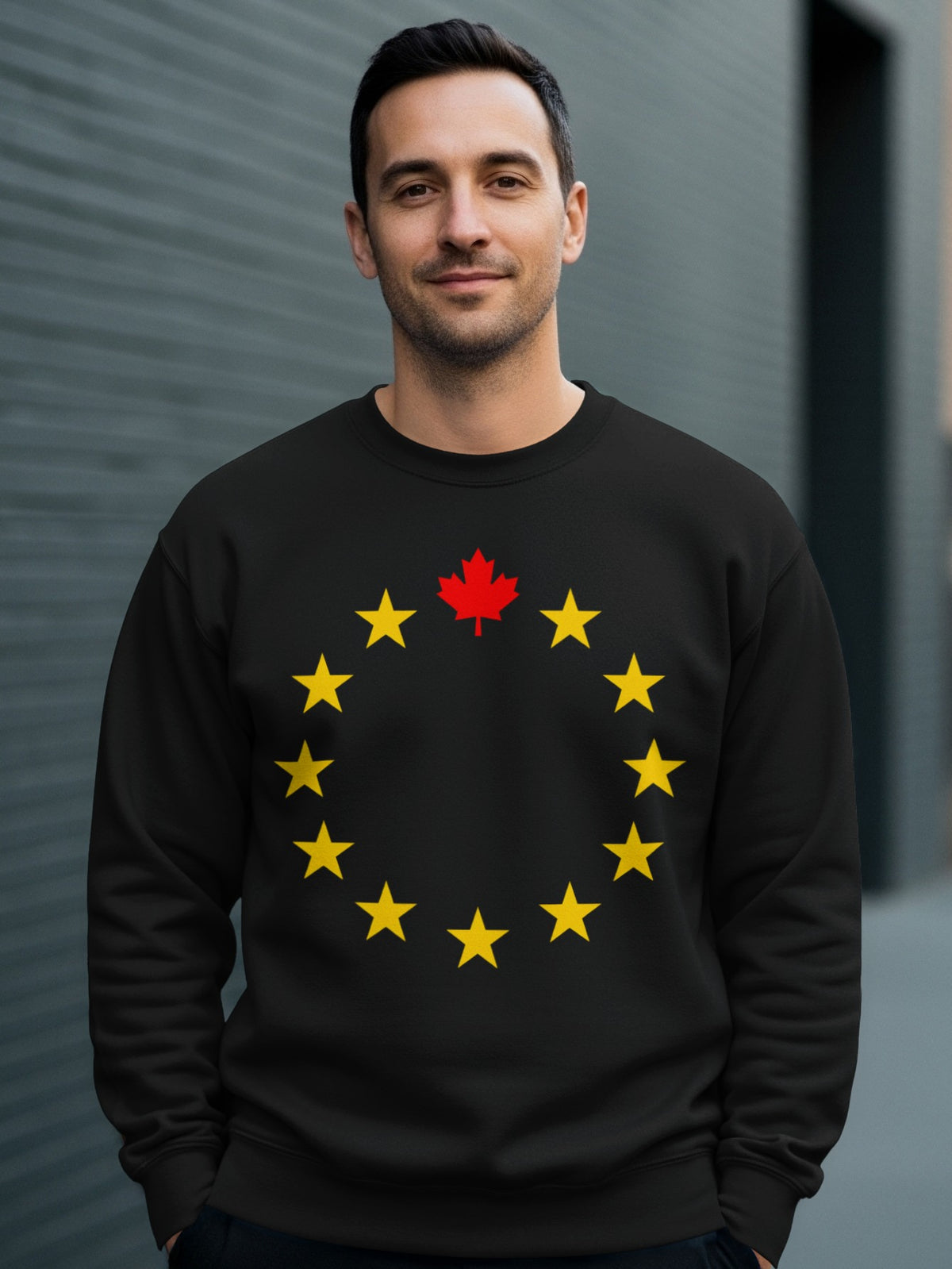 Black sweatshirt with a circle of yellow stars and a red maple leaf.