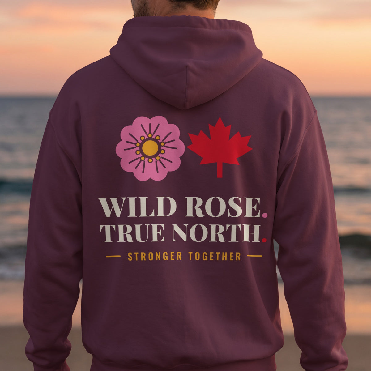 Maroon hoodie with pink wild rose, red maple leaf, and text.