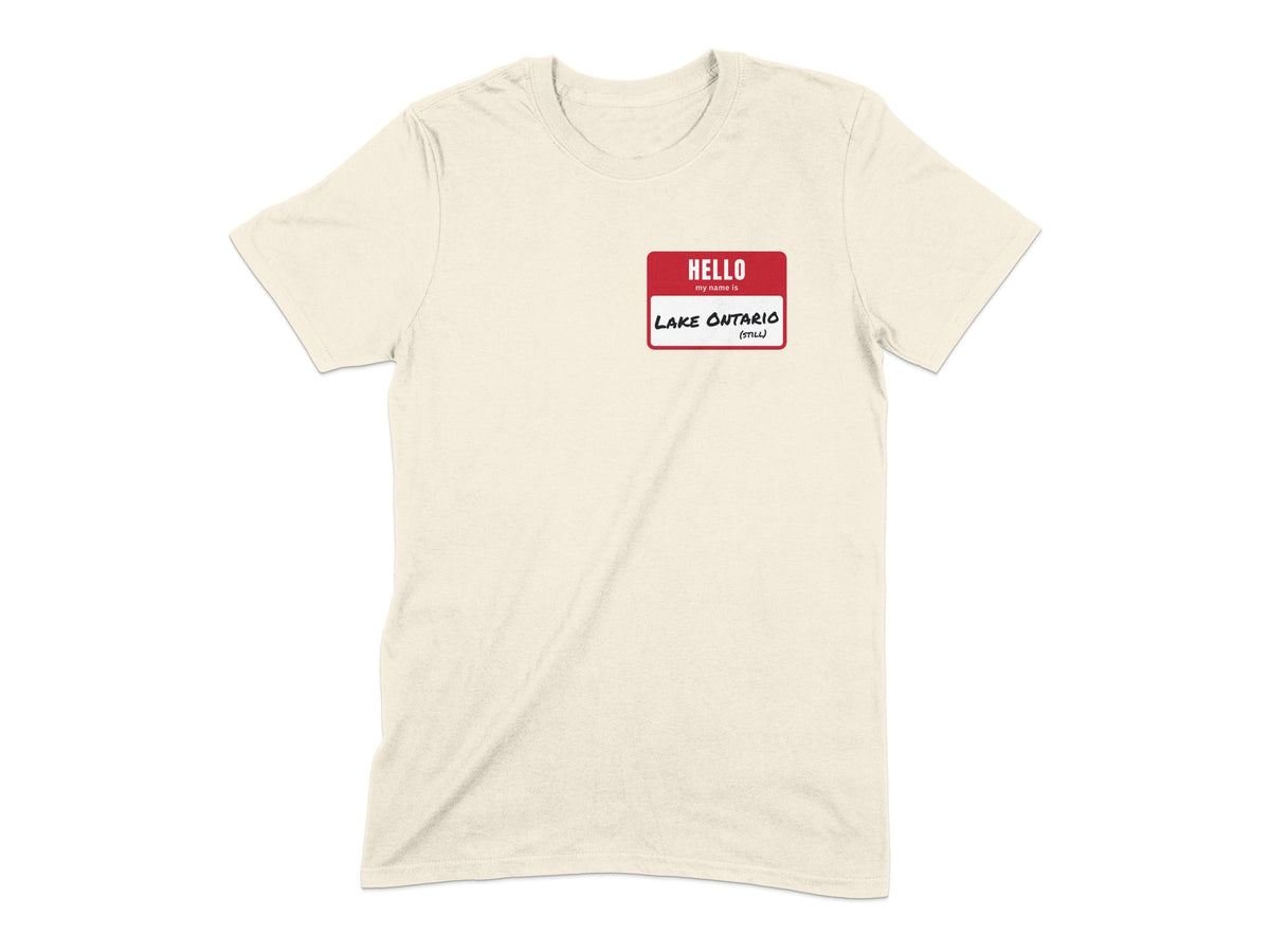 Cream t-shirt with a red name tag that says "HELLO my name is LAKE ONTARIO (STILL)".