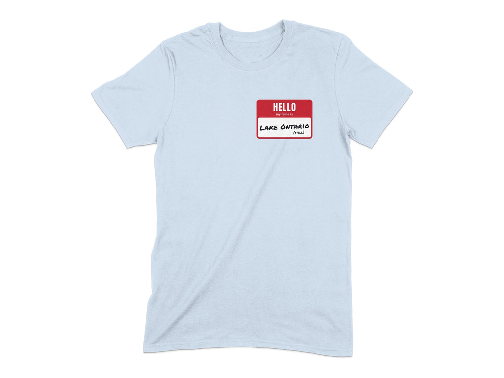 Light blue t-shirt with a red "hello my name is" tag with "Lake Ontario (Still)" written on it.