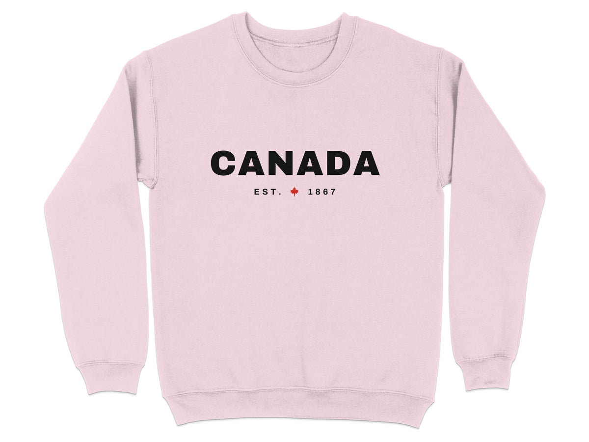 Pink sweatshirt with "CANADA EST. 1867" text and a red maple leaf.