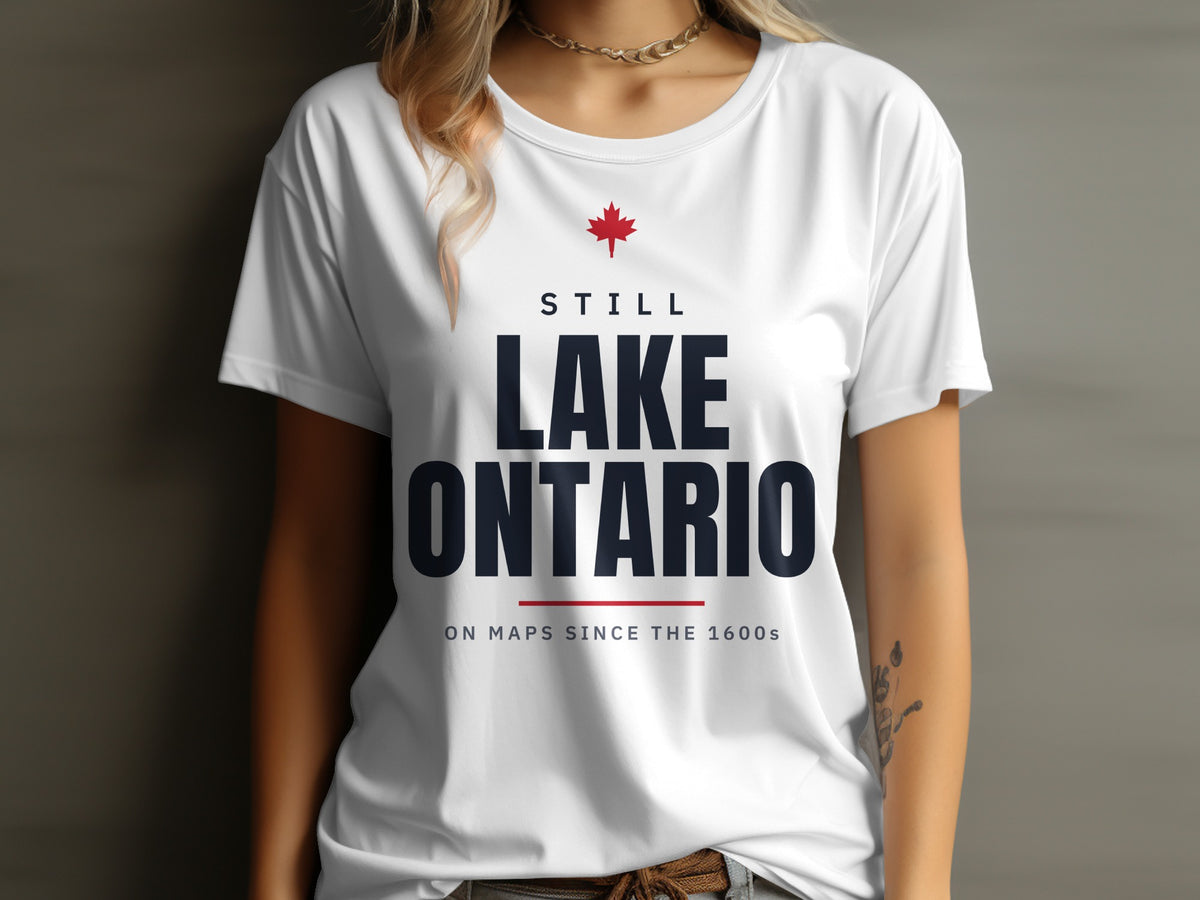 White t-shirt with red maple leaf and text "STILL LAKE ONTARIO ON MAPS SINCE THE 1600s".