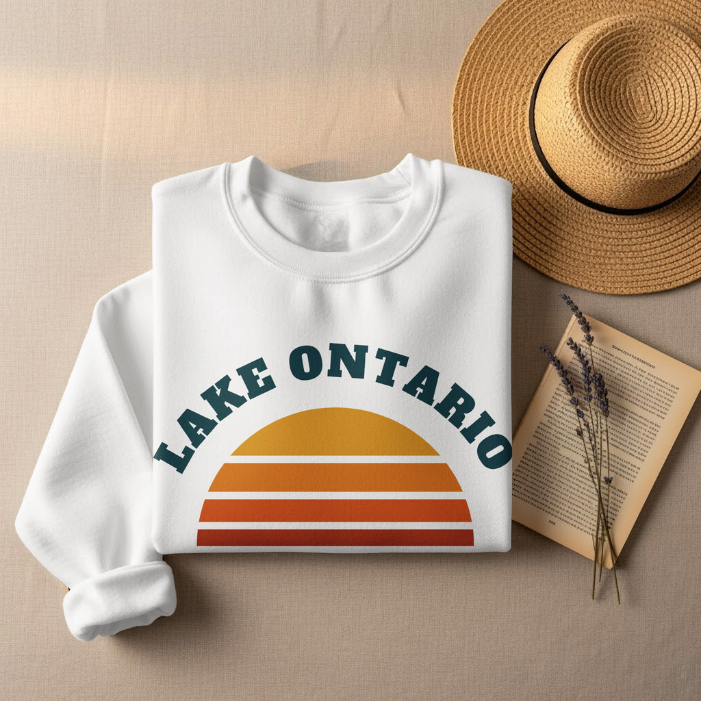 White sweatshirt with "Lake Ontario" text and a retro sunset graphic.