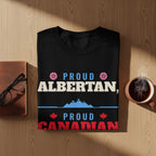 Black t-shirt with "Proud Albertan" and "Proud Canadian" text, mountains, and maple leaves.