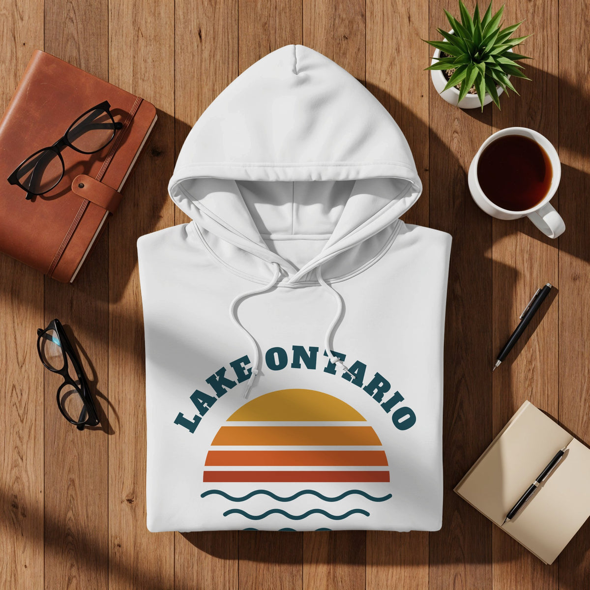 White hoodie with "Lake Ontario" text and sunset graphic.