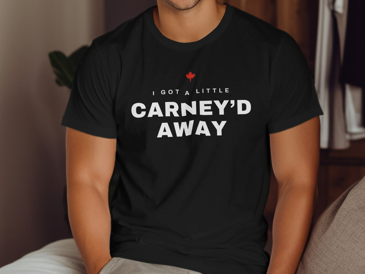 Black t-shirt with white text "I GOT A LITTLE CARNEY'D AWAY" and a red maple leaf.