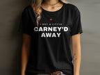 Black t-shirt with red maple leaf and white text "I GOT A LITTLE CARNEY'D AWAY".