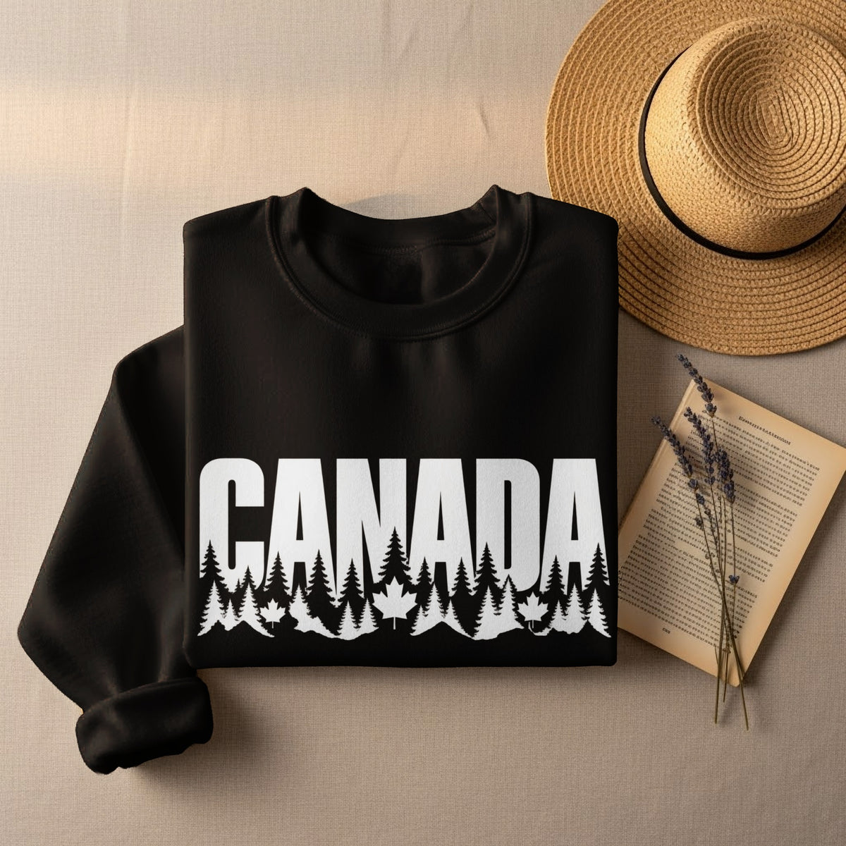 Black sweatshirt with "CANADA" text over pine trees and maple leaves.