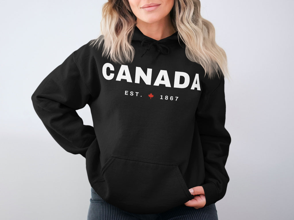 Black hoodie with "CANADA EST. 1867" and a maple leaf logo.